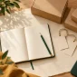 Blank labels, a notebook and packing materials arranged for planning a reseller brand